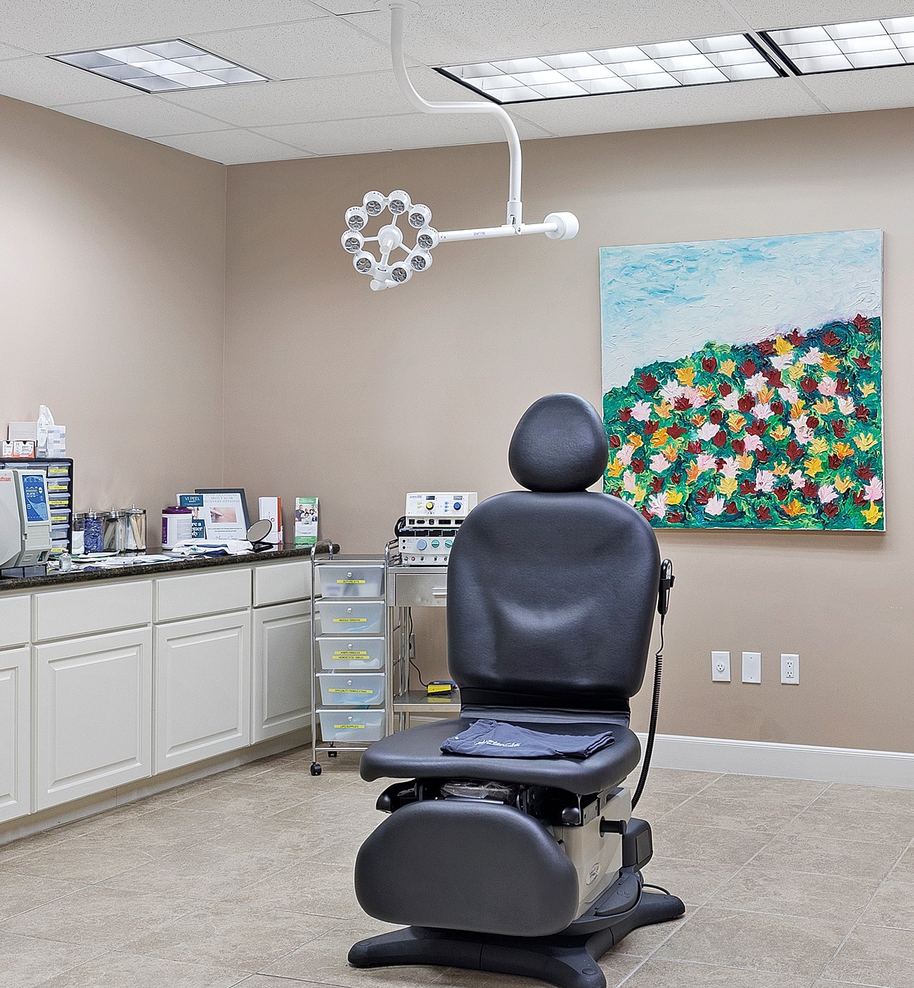 Medical examination room with a chair and equipment.