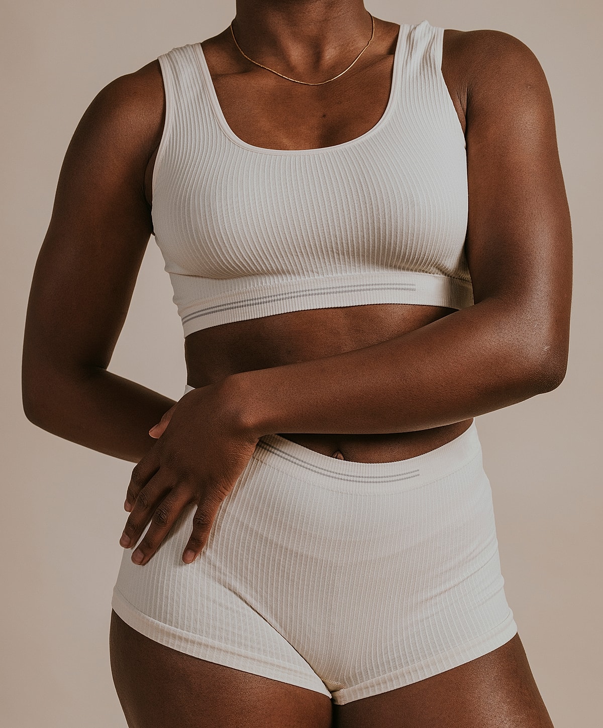 Model wearing beige ribbed athletic wear.