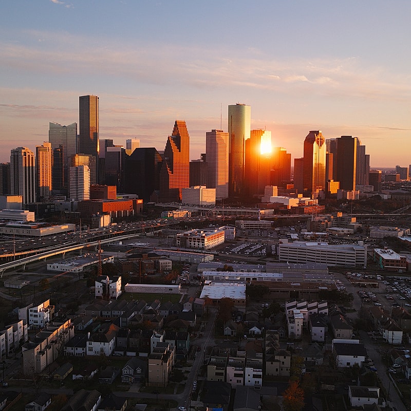 Houston skyline at sunset with warm light.